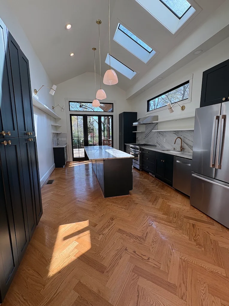 Bright Atlanta kitchen with skylights and herringbone floors cleaned by White Rabbit Cleaning
